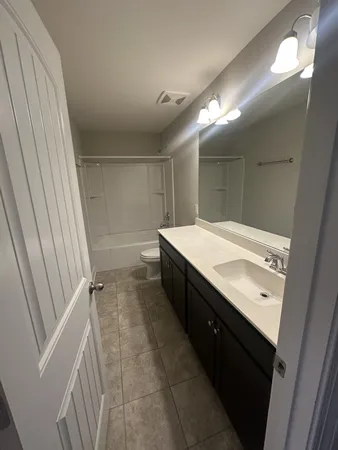 a bathroom with a double vanity sink and mirror