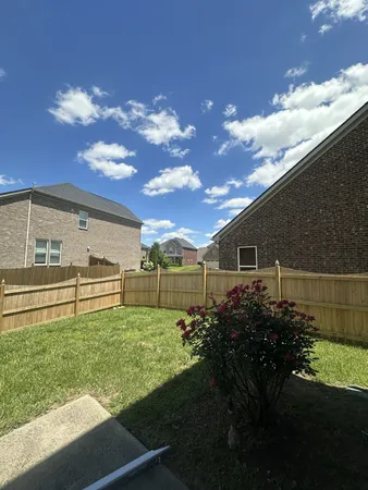 a backyard of a house with lots of green space and garden