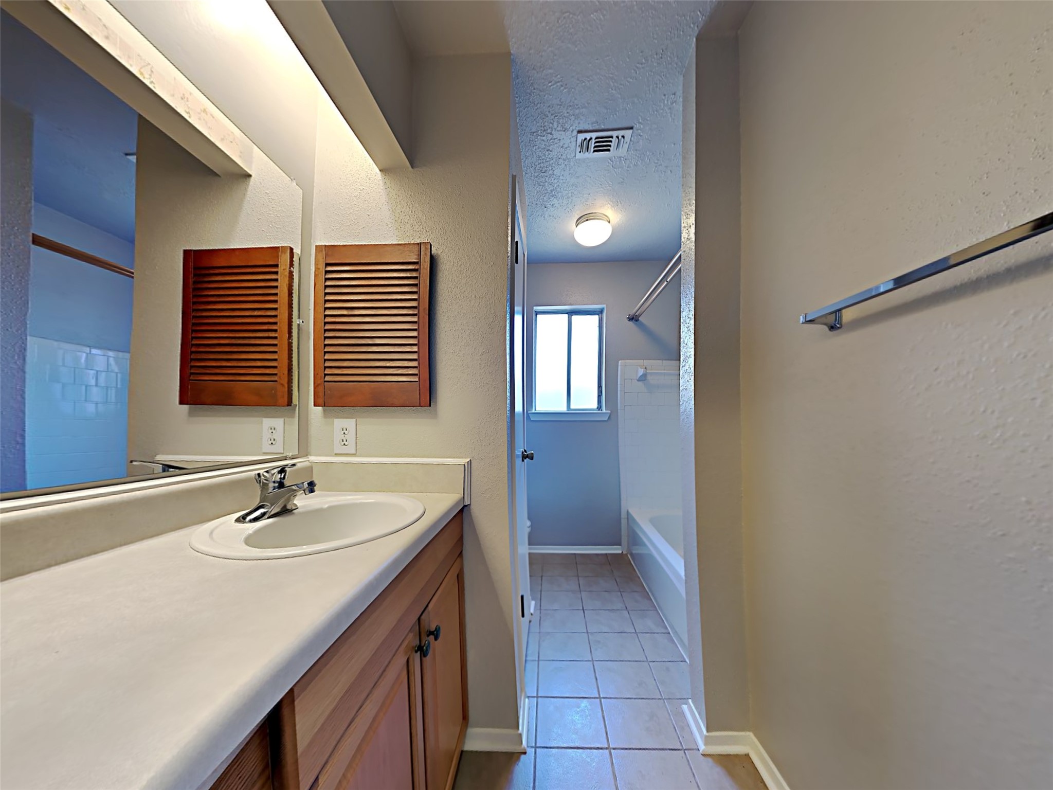 14919 Wainsfield Lane Channelview, TX 77530 - Photo 11 of 17 a bathroom with a sink and a mirror