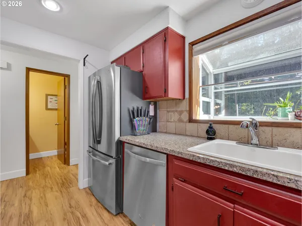 a kitchen with a sink appliances and cabinets