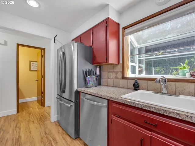 a kitchen with a sink appliances and cabinets