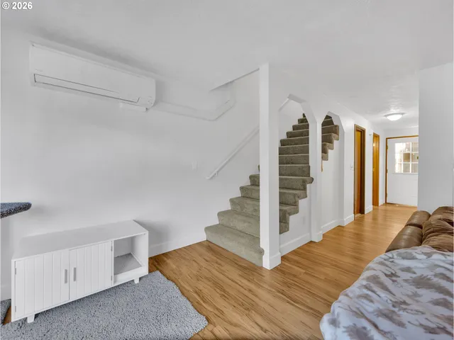 a view of a bedroom with wooden floor and closet