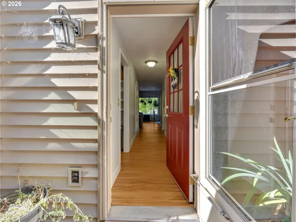 a view of a hallway with wooden cabinet and door
