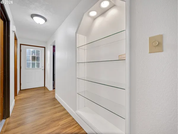 a view of an empty room with wooden floor