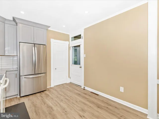 a kitchen with white cabinets appliances and a sink