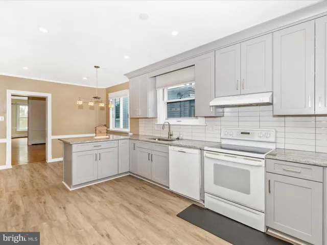 a view of a room with wooden floor and windows