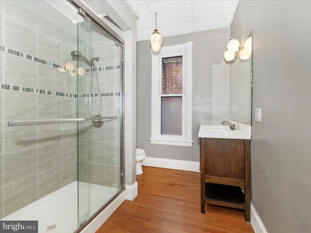 a view of a brick house with a large windows and a tree