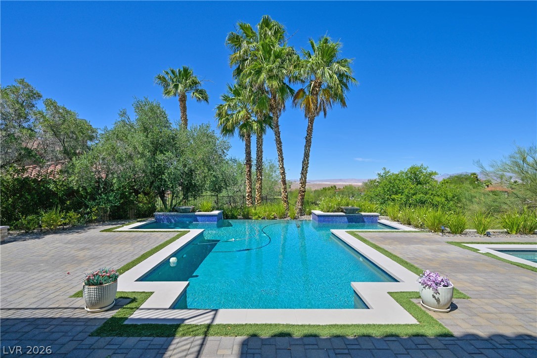 6 Rue Du Ville Henderson, NV 89011 - Photo 72 of 99 This tranquil outdoor oasis features a refreshing pool, perfect for relaxation and enjoying scenic views.