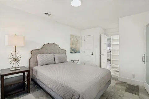 a bedroom with a bed and a lamp