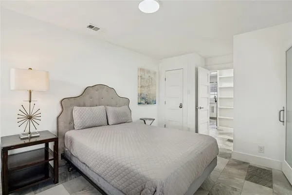 a bedroom with a bed and a lamp