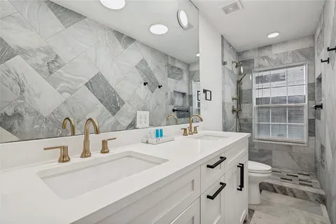 a bathroom with a sink double vanity and a shower