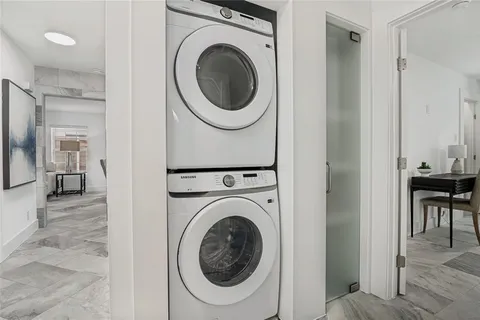 a view of a hallway with washer and dryer