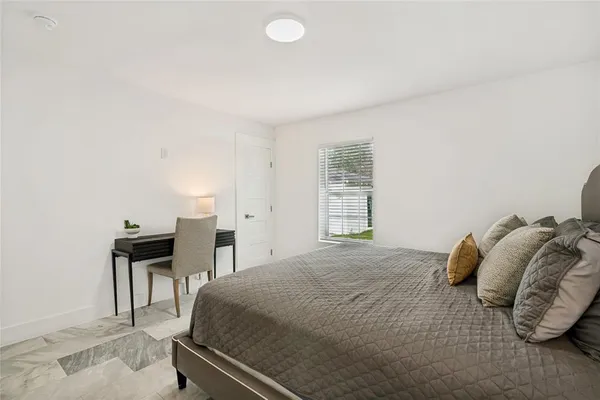 a bedroom with a bed and a window