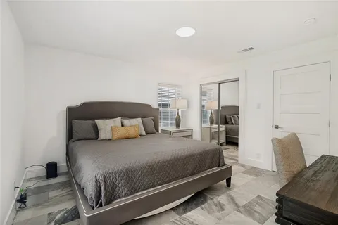 a bedroom with a bed and a couch