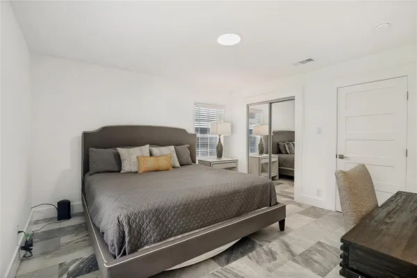 a bedroom with a bed and a couch