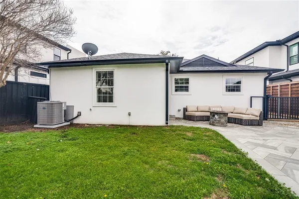 a view of a house with a yard and sitting area