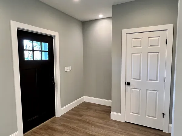 a view of empty room with wooden floor