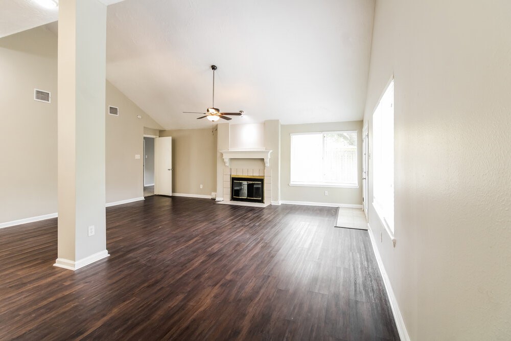 3635 Lost Oak Drive Spring, TX 77388 - Photo 6 of 16 an empty room with wooden floor fireplace and windows