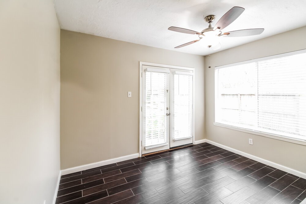 3635 Lost Oak Drive Spring, TX 77388 - Photo 8 of 16 an empty room with wooden floor fan and windows