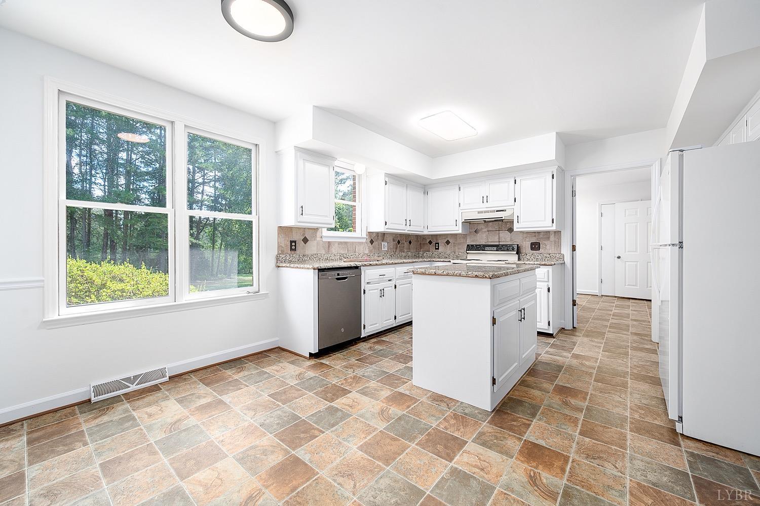 1309 White Fall Road Gretna, VA 24557 - Photo 14 of 64 a kitchen with stainless steel appliances granite countertop a stove a sink dishwasher and a refrigerator