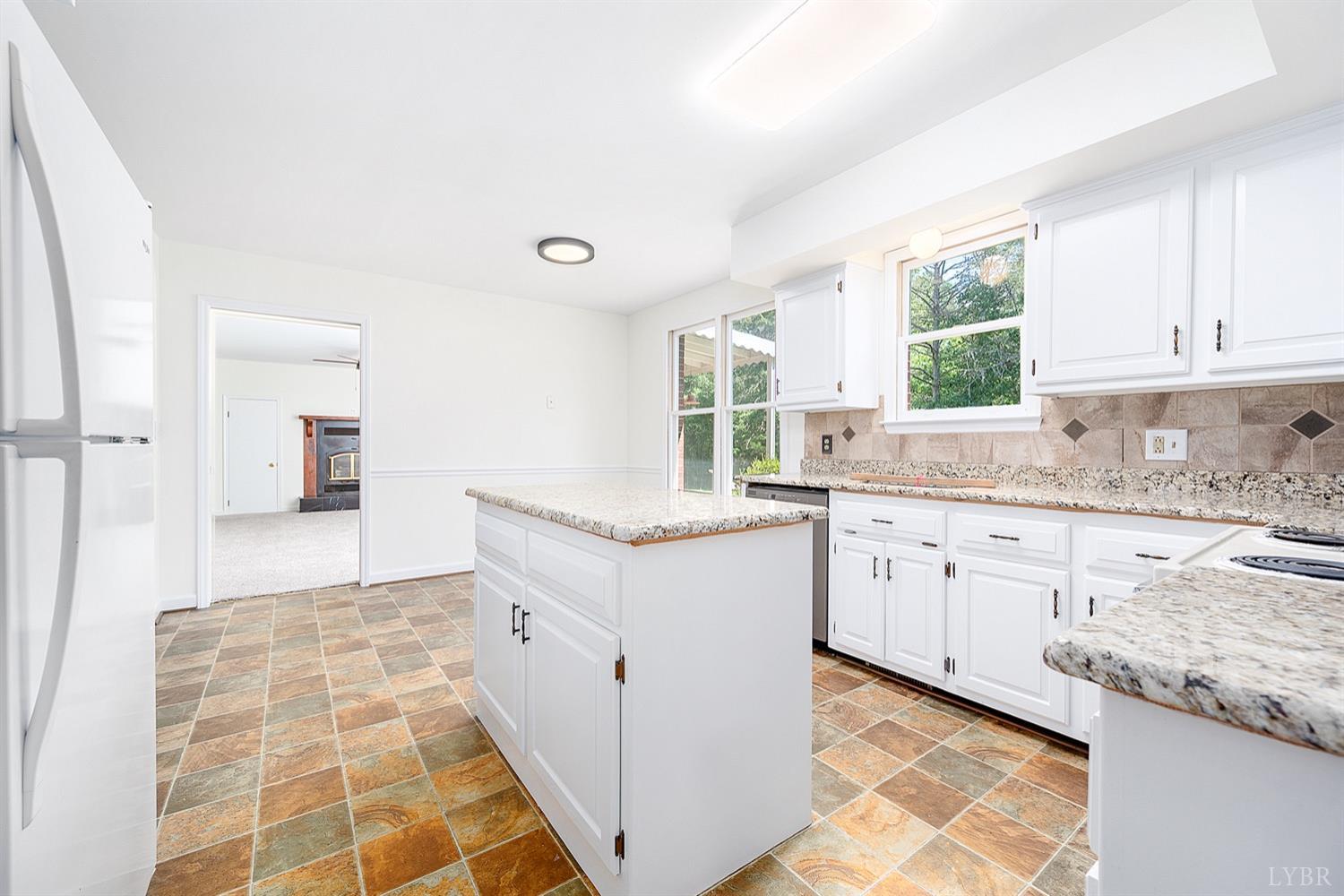 1309 White Fall Road Gretna, VA 24557 - Photo 16 of 64 a kitchen with granite countertop white cabinets and white appliances