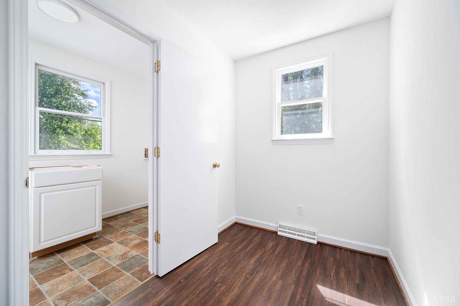 1309 White Fall Road Gretna, VA 24557 - Photo 22 of 64 an empty room with wooden floor and windows