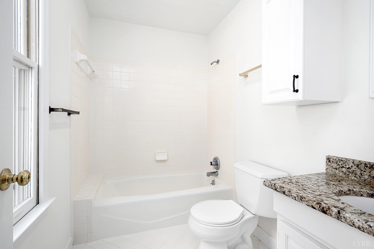 1309 White Fall Road Gretna, VA 24557 - Photo 30 of 64 a bathroom with a granite countertop bathtub shower sink vanity and toilet