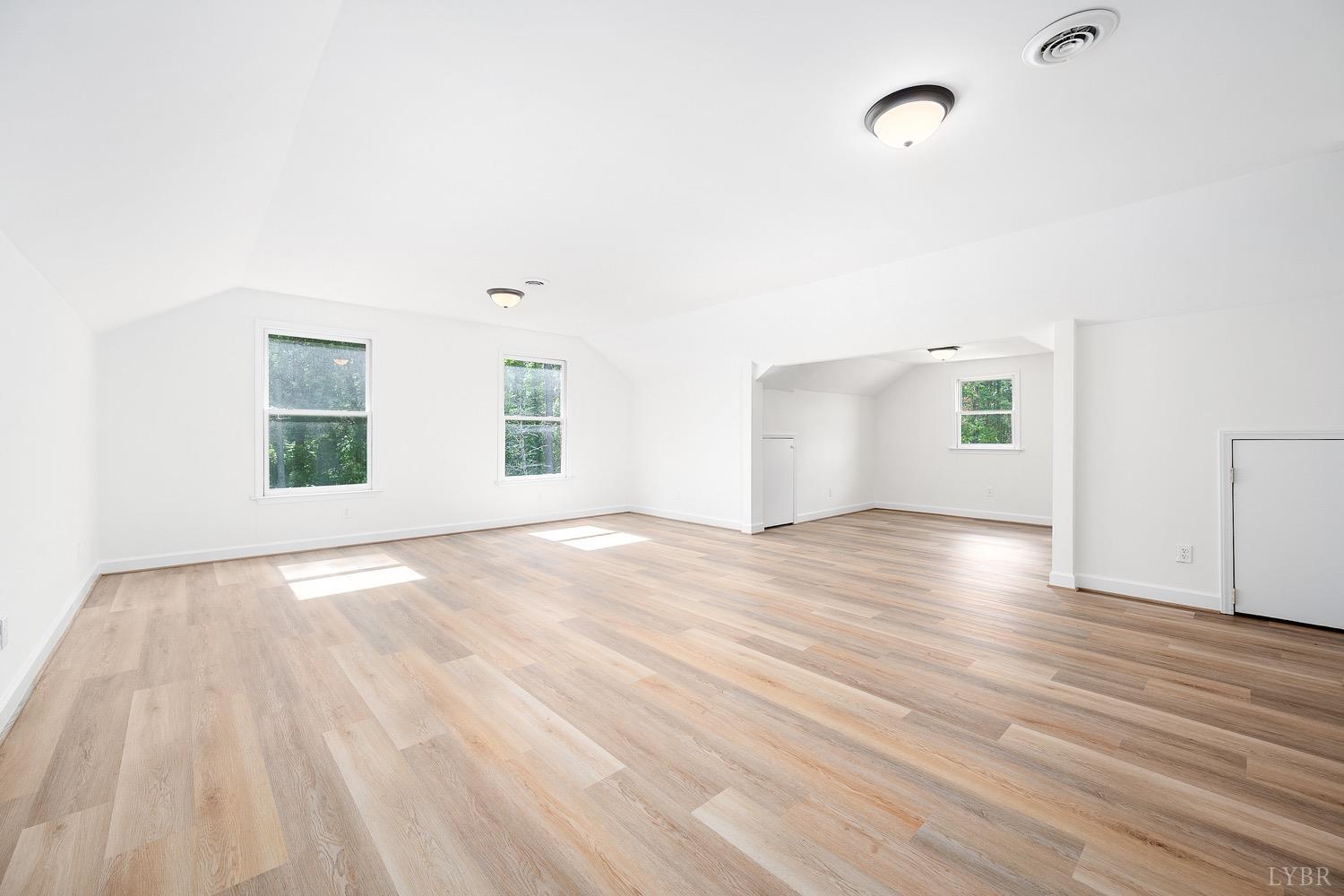 1309 White Fall Road Gretna, VA 24557 - Photo 37 of 64 an empty room with wooden floor and windows