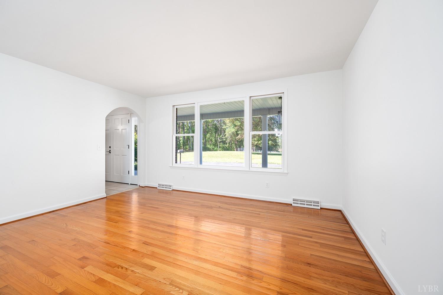 1309 White Fall Road Gretna, VA 24557 - Photo 9 of 64 an empty room with wooden floor and windows