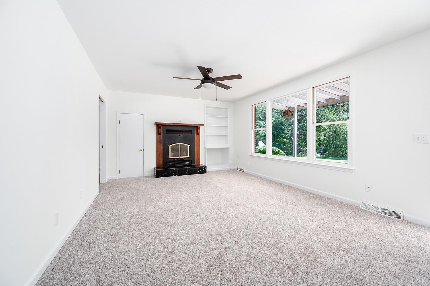 1309 White Fall Road Gretna, VA 24557 - Photo 10 of 64 an empty room with windows and ceiling fan