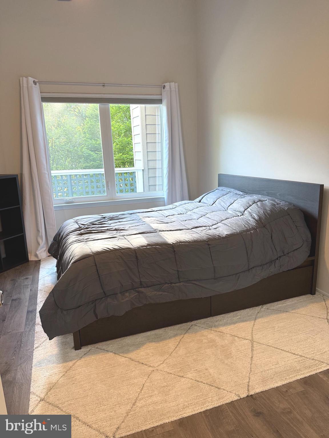 11743 Summerchase Circle, Unit B Reston, VA 20194 - Photo 11 of 25 a bedroom with a bed and a large window