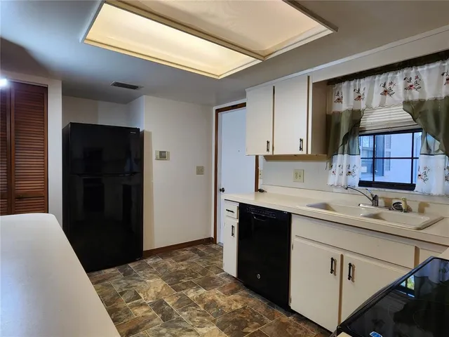 a kitchen with a sink and cabinets