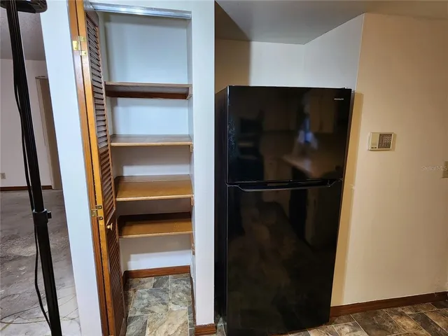 a refrigerator freezer sitting inside of a room