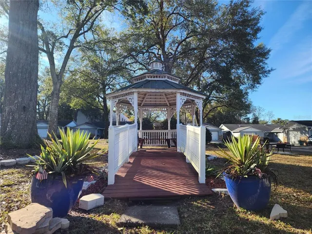 a view of a house with backyard and sitting area