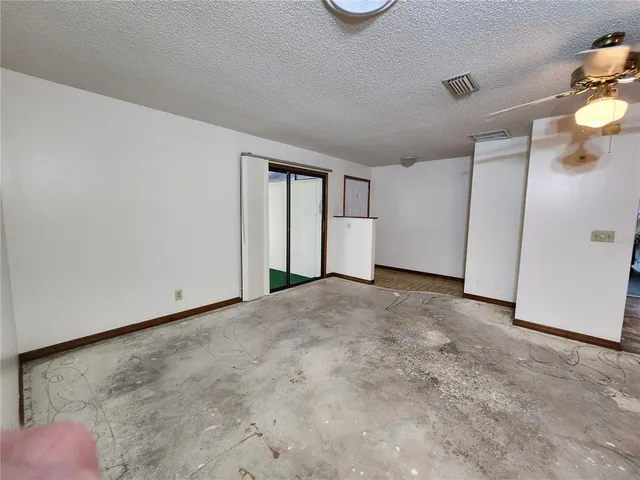 a view of an empty room and a window