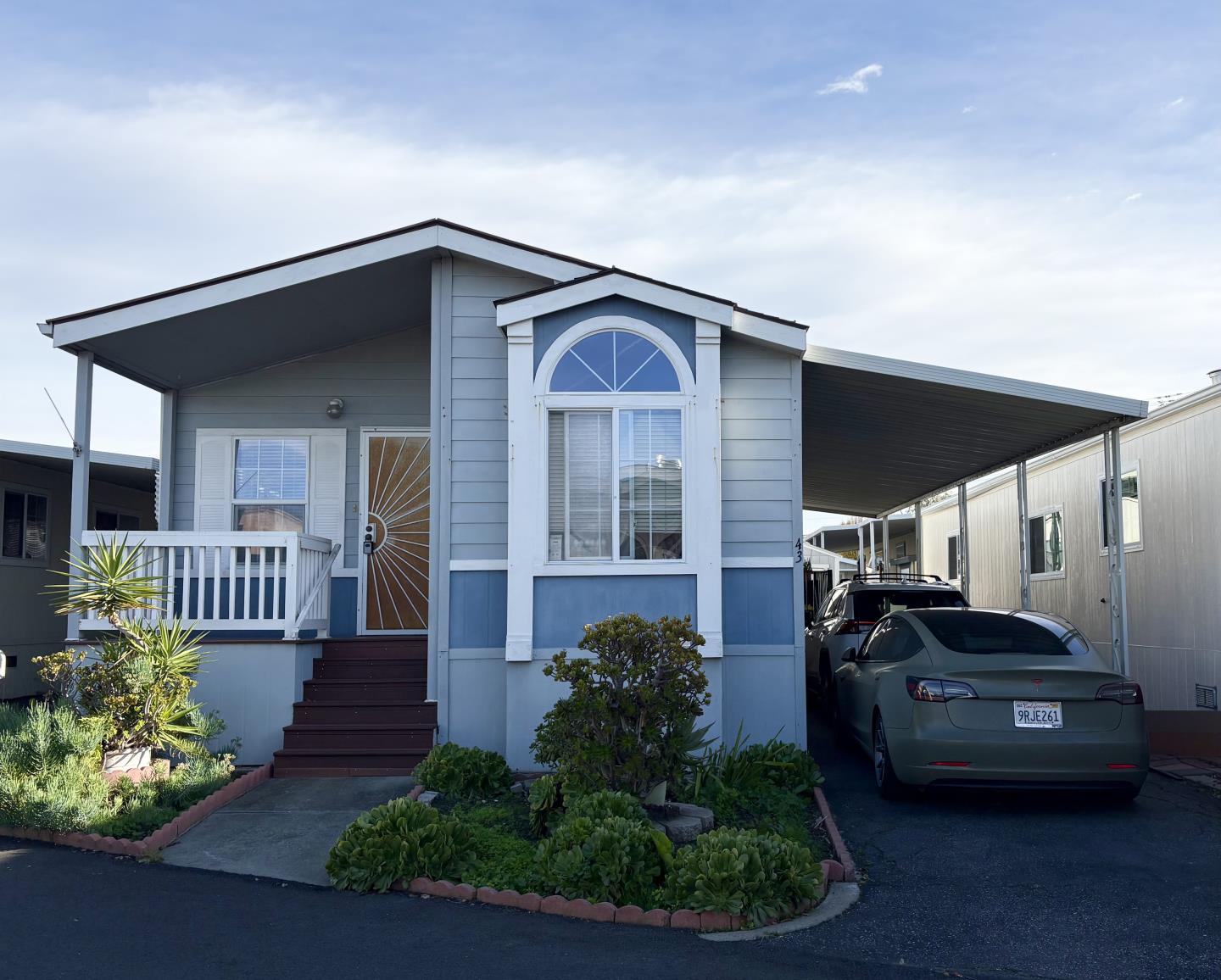 a front view of a house with garden