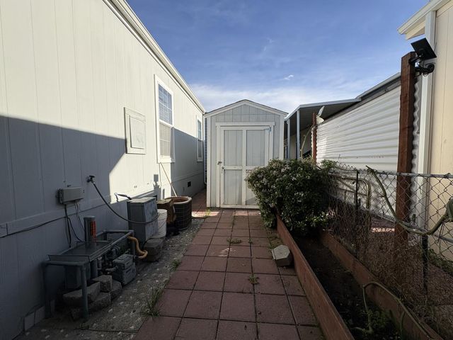 a backyard of a house with table and chairs