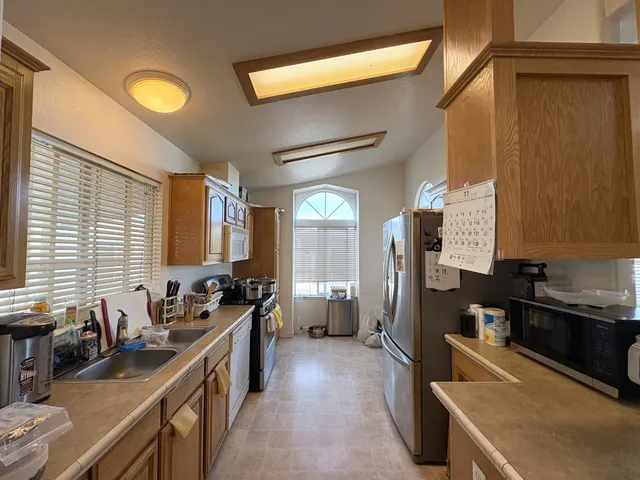 a kitchen with lots of counter space and windows