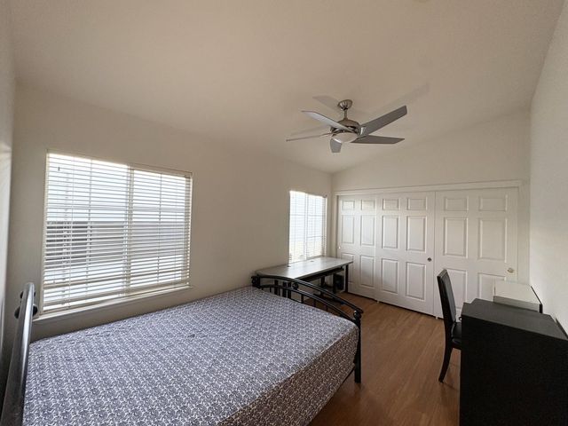 a bedroom with a bed and window