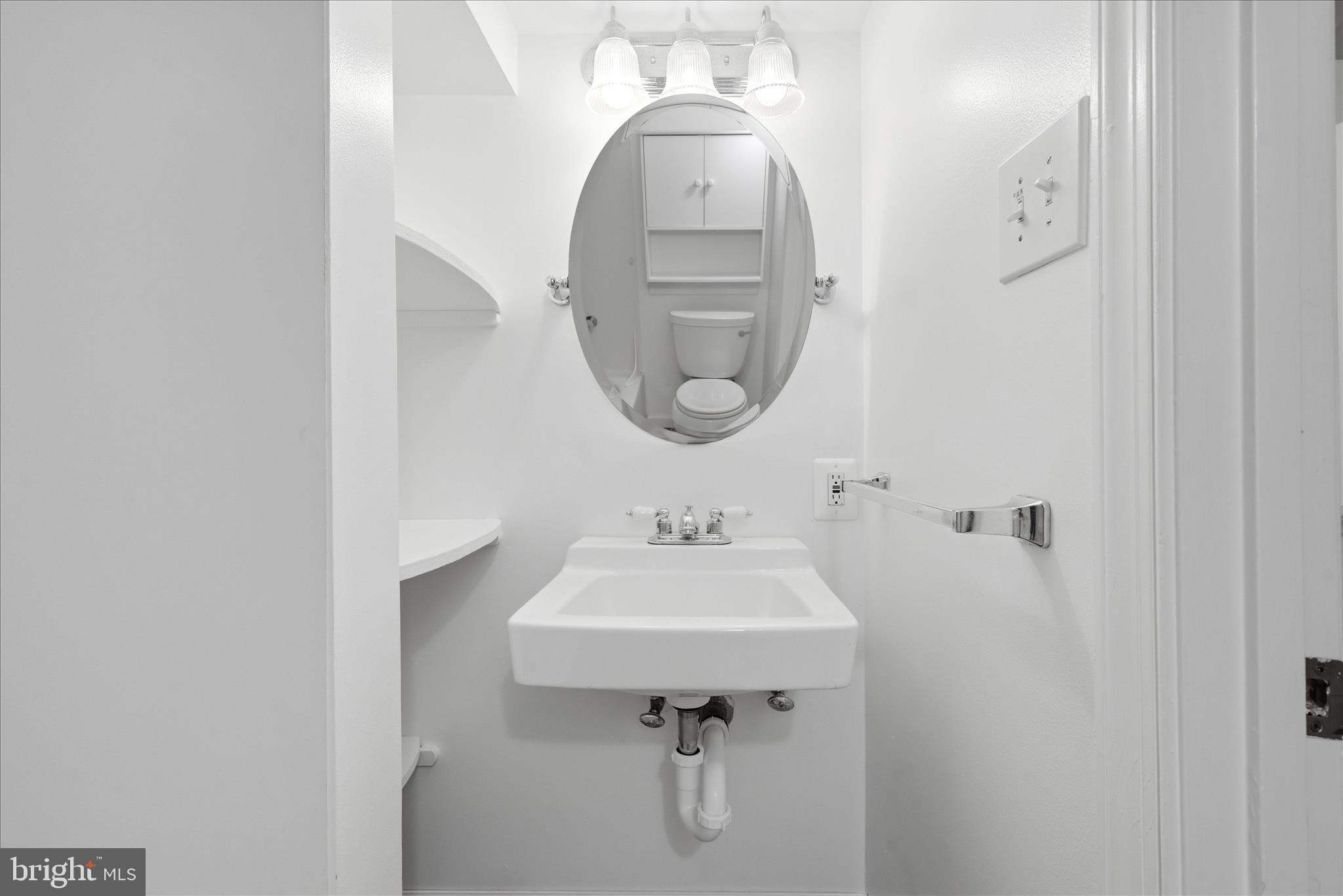 5446 Lighthouse Lane Burke, VA 22015 - Photo 25 of 36 a bathroom with a sink a mirror and a toilet