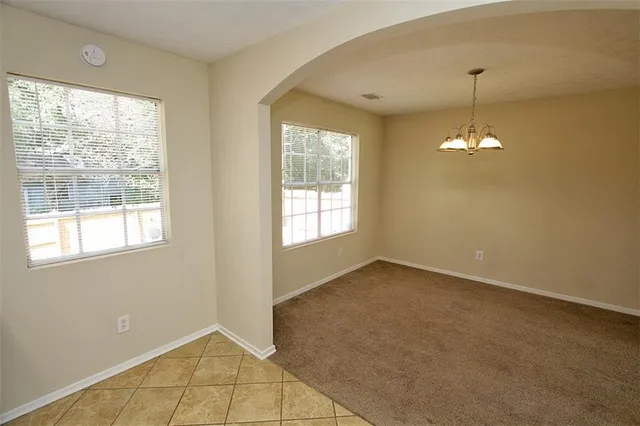 a kitchen with granite countertop a stove a sink and a refrigerator