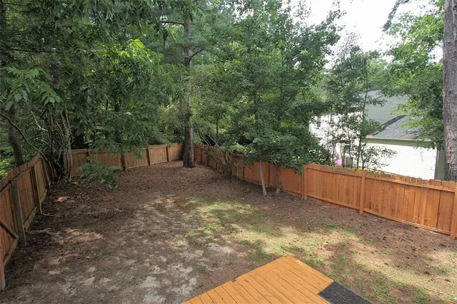a view of a backyard with large trees