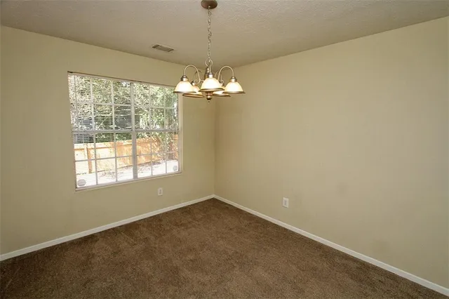 a view of a windows and a chandelier in big room