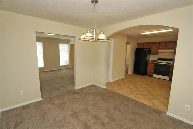 a kitchen with stainless steel appliances granite countertop a stove a sink dishwasher and a refrigerator