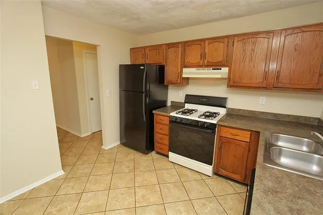 a view of a hallway with closet and a bathroom