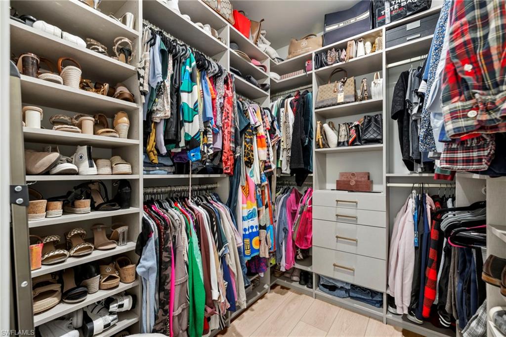2170 Yellowfin Circle Naples, FL 34114 - Photo 15 of 26 a view of walk in closet with clothes and shoes