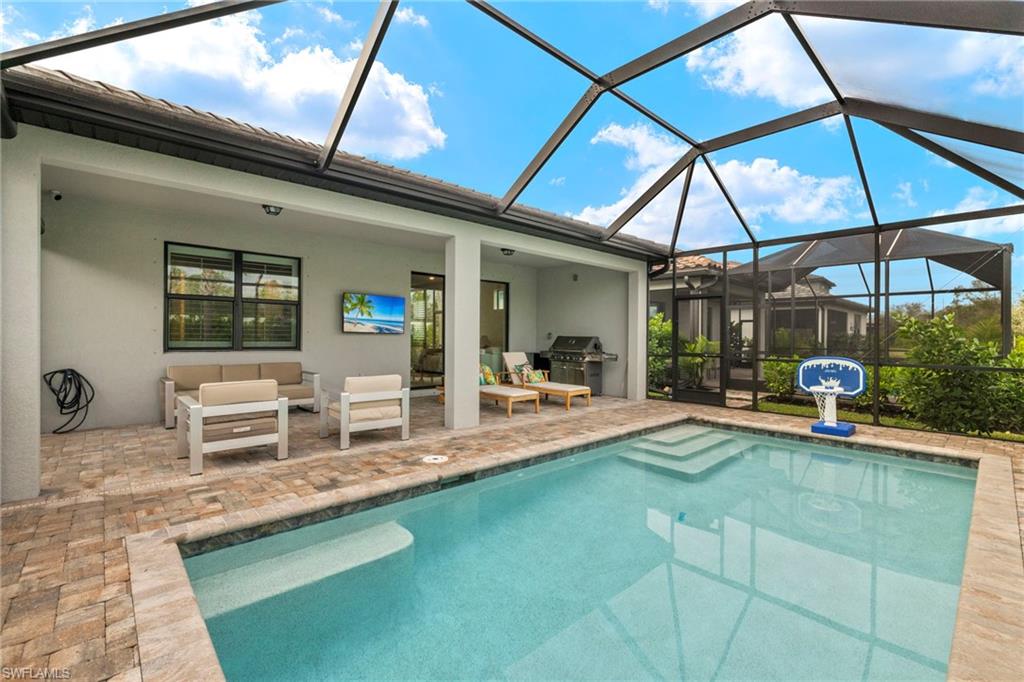 2170 Yellowfin Circle Naples, FL 34114 - Photo 19 of 26 a view of a swimming pool with a patio