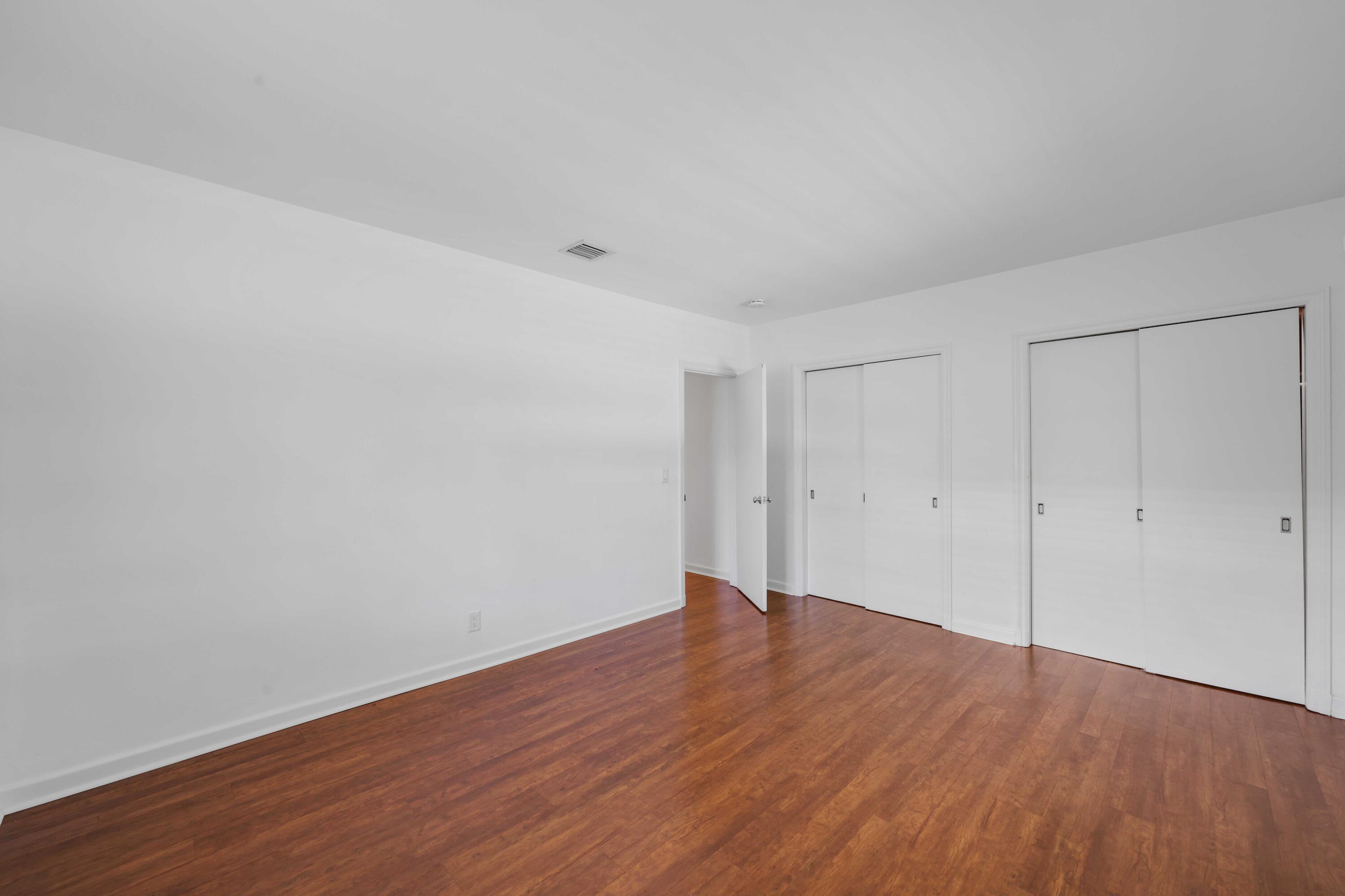 246 Merrain Road Palm Beach, FL 33480 - Photo 12 of 31 a view of an empty room with wooden floor