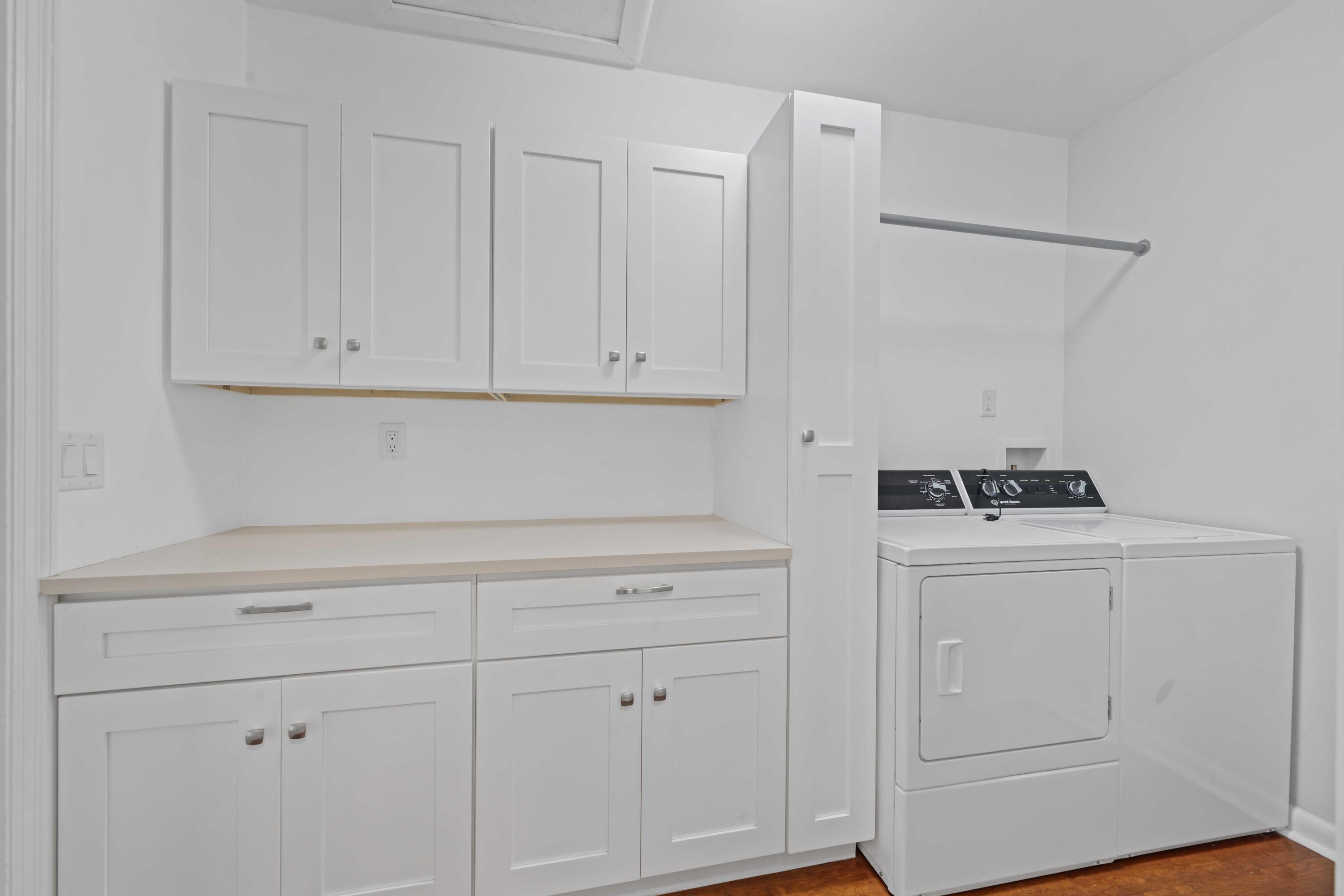 246 Merrain Road Palm Beach, FL 33480 - Photo 16 of 31 a kitchen with white cabinets and white appliances