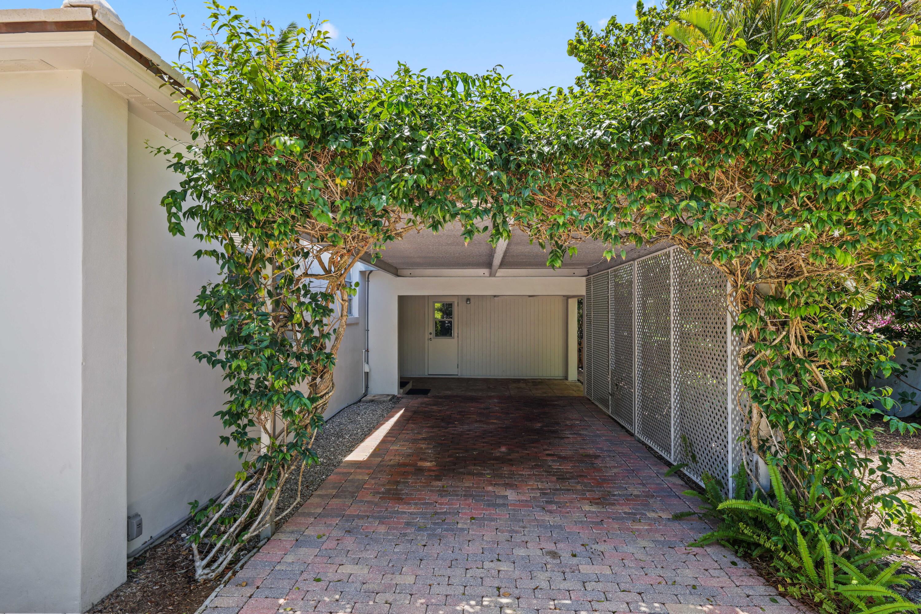 246 Merrain Road Palm Beach, FL 33480 - Photo 18 of 31 a view of a yard with potted plants and large trees